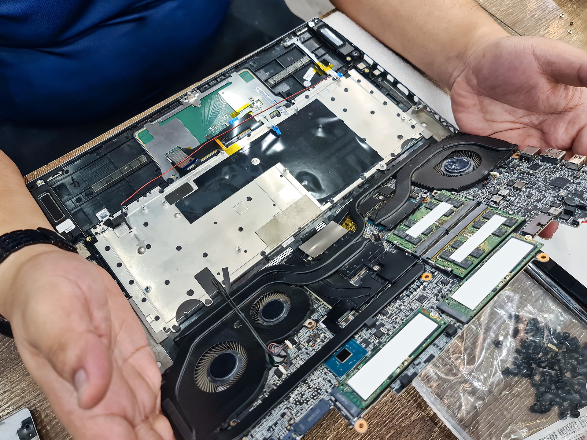 Computer technician disassembling mainboard with circuit of laptop repairing and upgrade technology